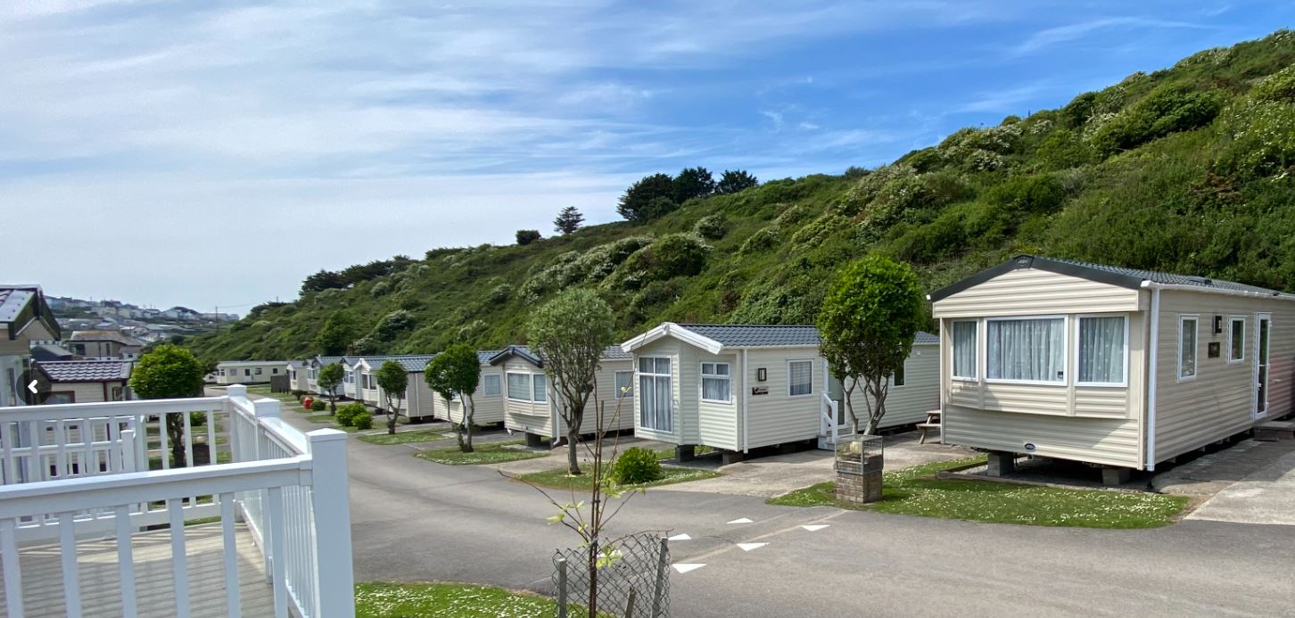 A view of holiday homes with natural bushes growing behind