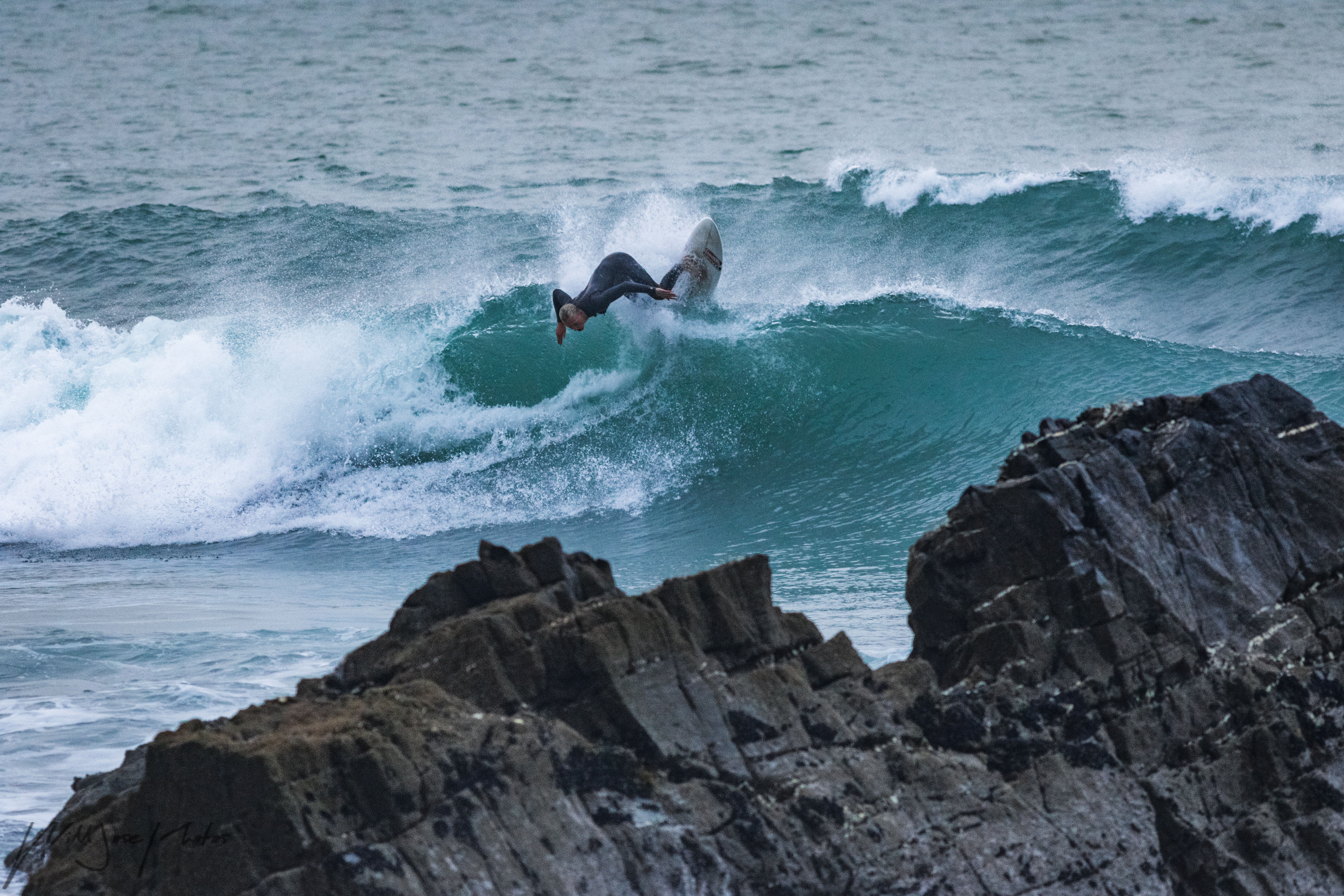 A surfer at high tide, Sandymouth