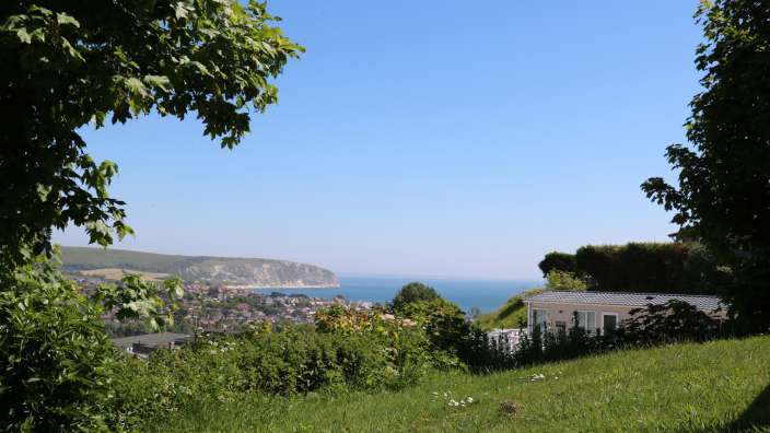 Views over Swanage bay of sea with forests for Dorset caravan holidays