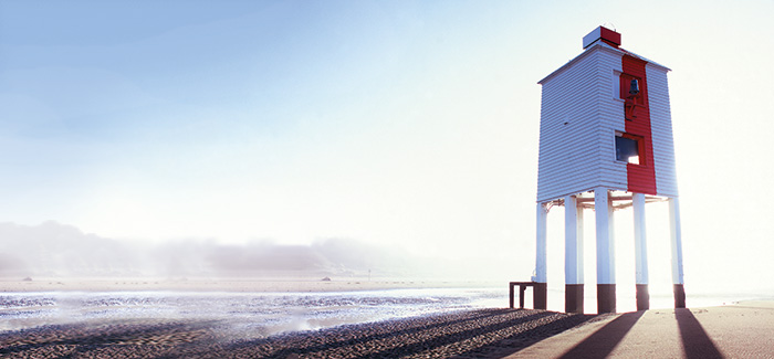Building on a beach on a sunny day with sea mist