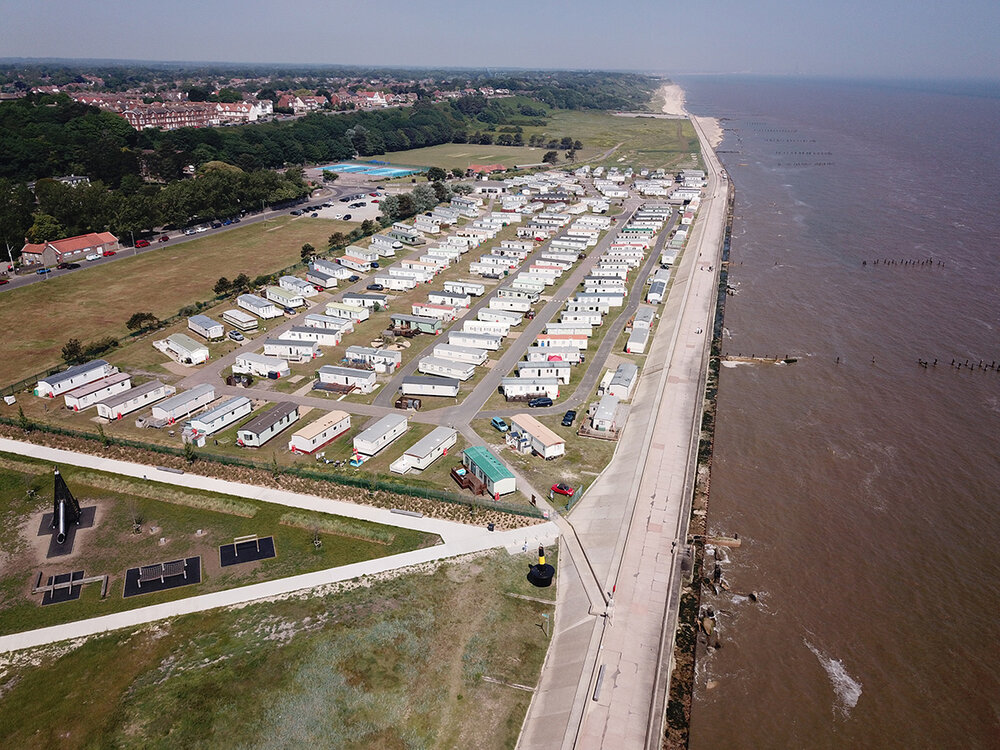 An arial view of the holiday park alongside the coastline and town in the distance