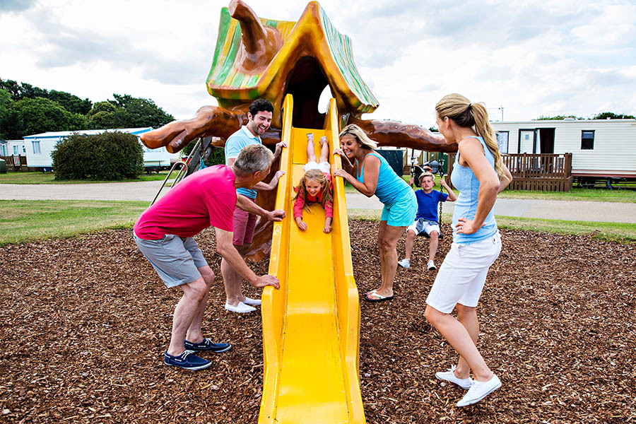 A family having fun in a holiday play park