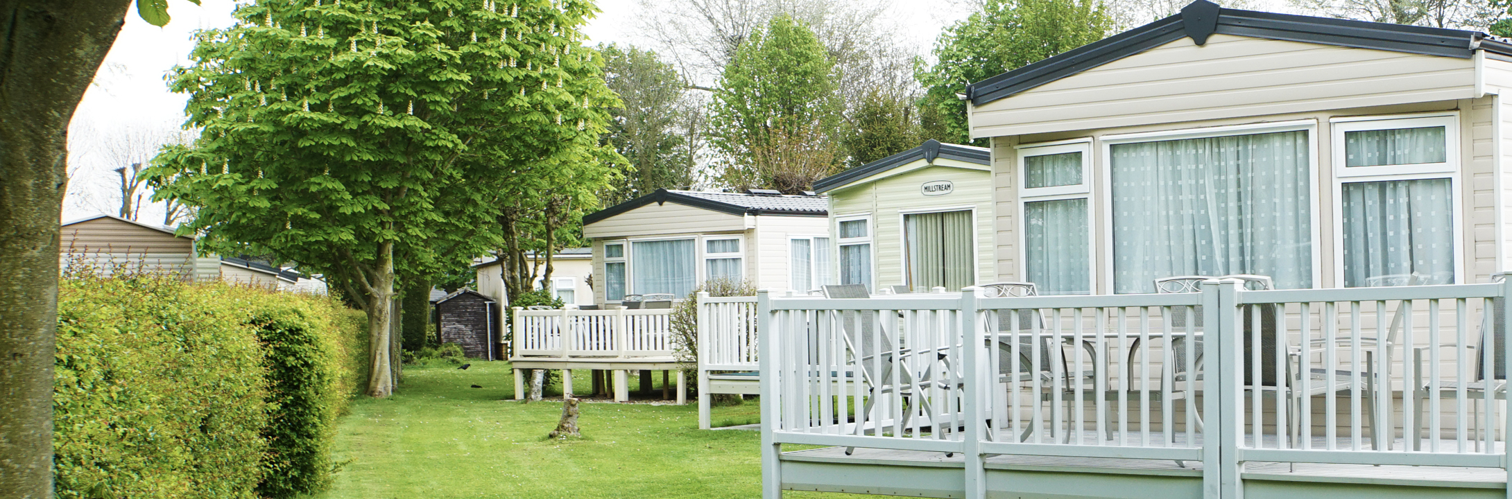 A view of holiday homes and green trees at Woodthorpe Leisure Park in Lincolnshire