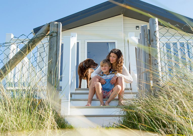 Two people and their dog at Barmouth best holiday parks in Wales