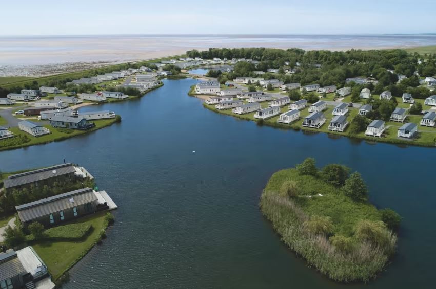 An arial view of the holiday park, lake and coastline
