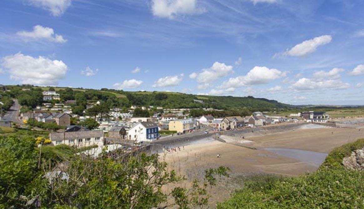 A small village next to a deserted beach on a warm sunny day