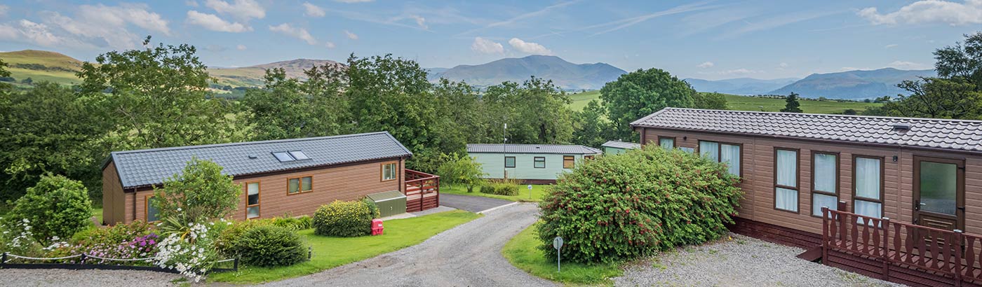 A view through a valley with holiday homes in the forground