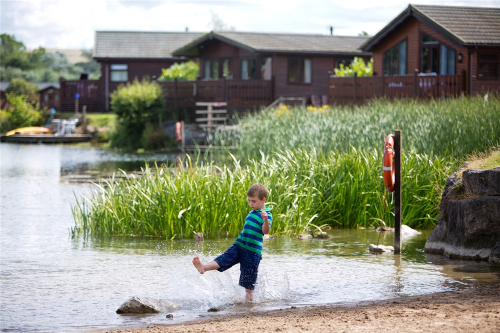  lake surrounded by holiday homes at dog friendly holiday parks in the lake district