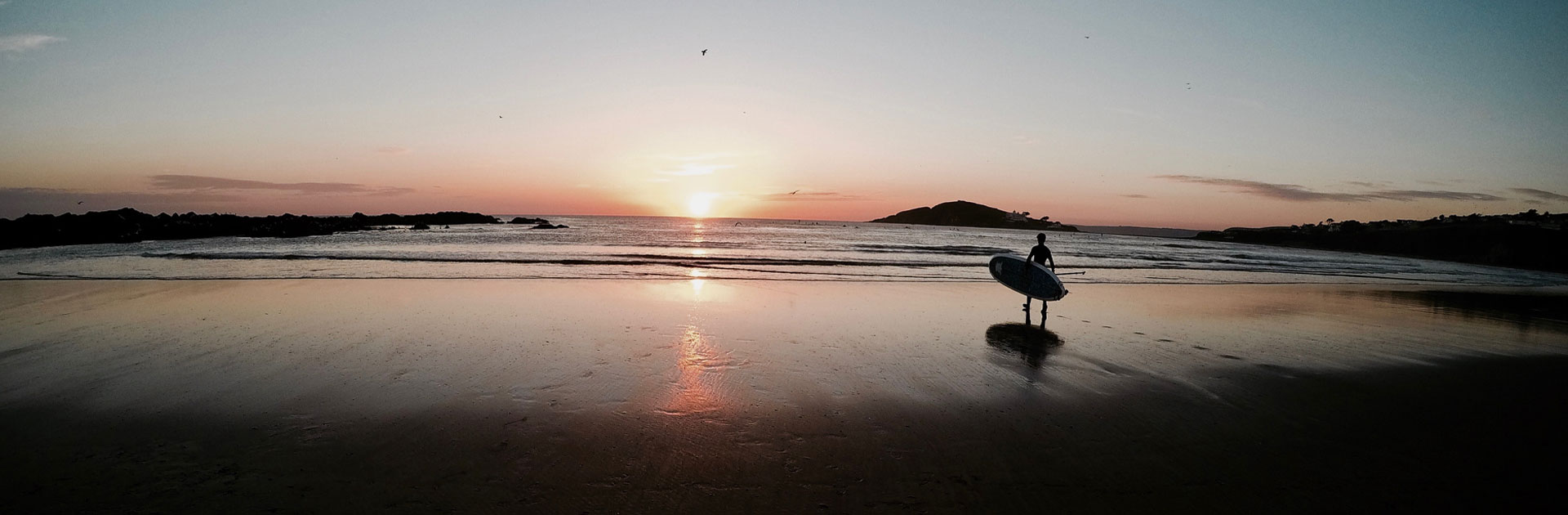 Bantham Beach at Sunset with a Lone Surfer Walking Towards the Surf