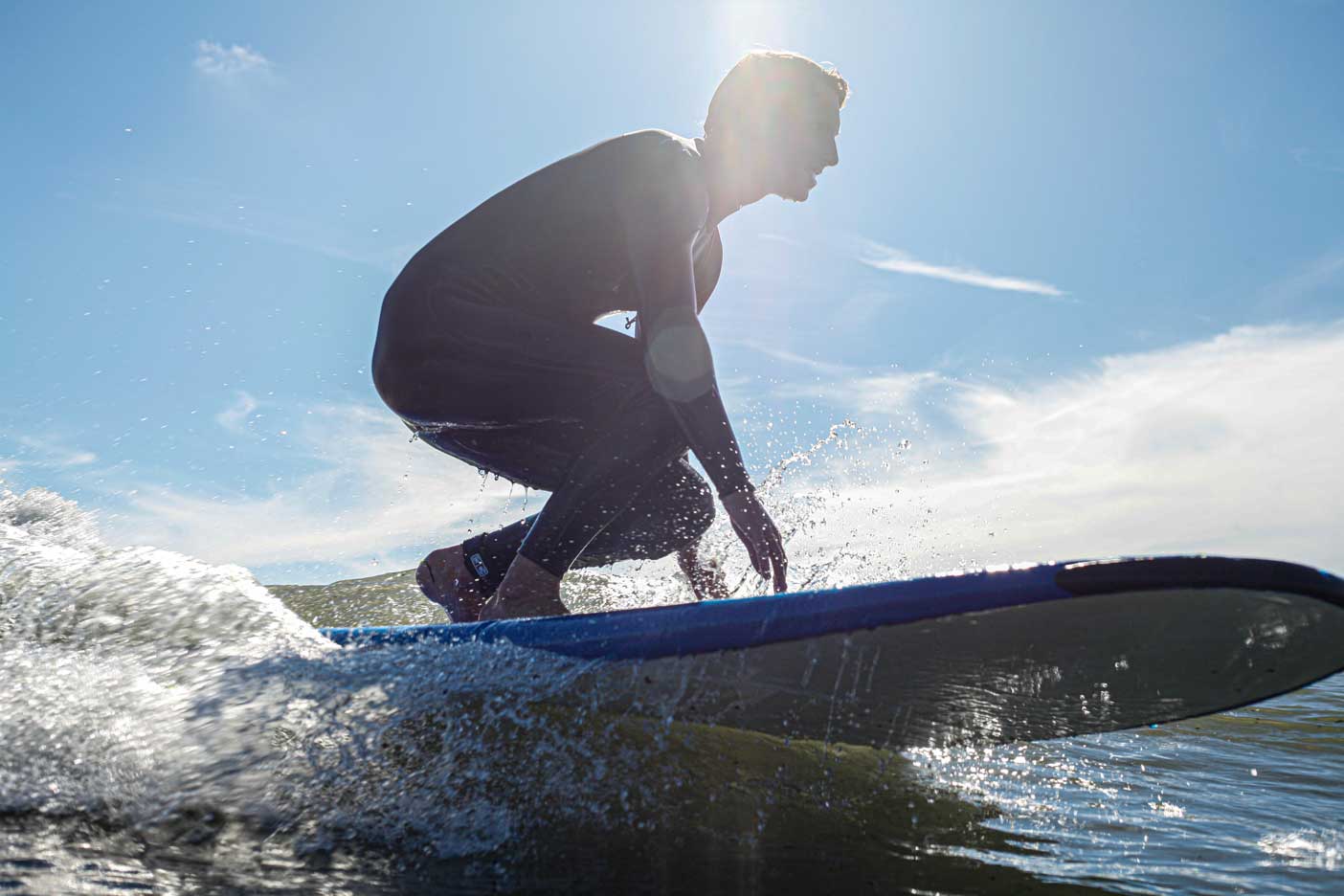 A Person Surfing on a North Devon Beach on a Bright Sunny Day