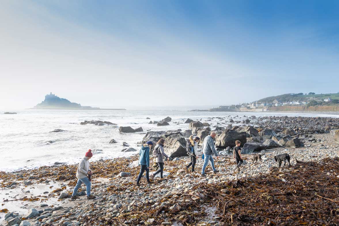 A Group of Walkers Enjoing the Cornish Coastline near St Michaels Mont on a Cold Winters Day