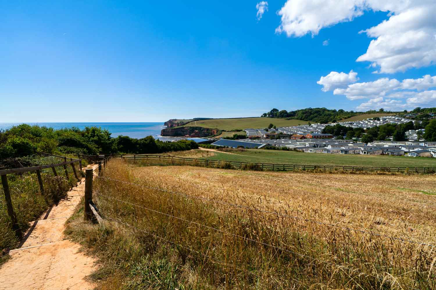 A View of a Walking Spot Nearing a Holiday Park set against the Coastline