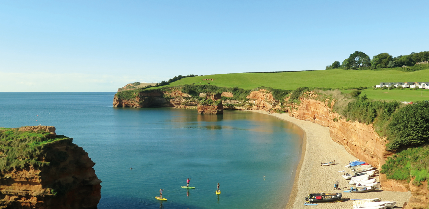 People Riding SUP's on the Sea in a Beautifully Shelteres Devonshire Cove
