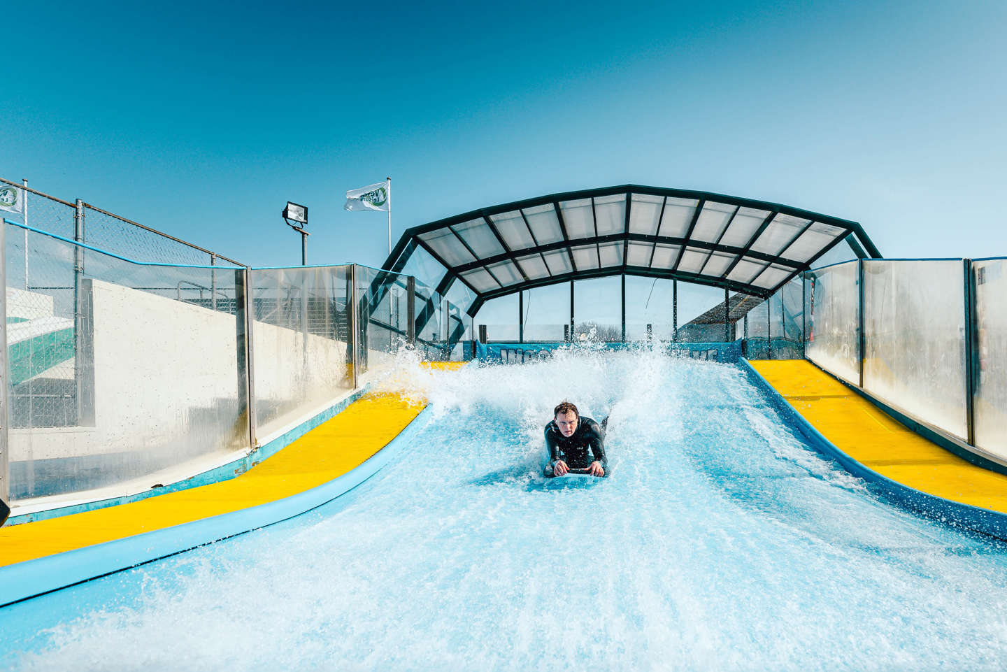 A Person Body Boarding on a Surf Simulator on a Holiday Park Near Woolacombe