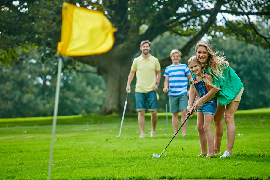 A Family Playing Golf on the Holiday Parks Onsite Golf Course in Cornwall 