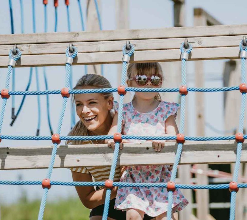 A Mother and Child Playing on the Adventure Playground on a Cornish Holiday Park