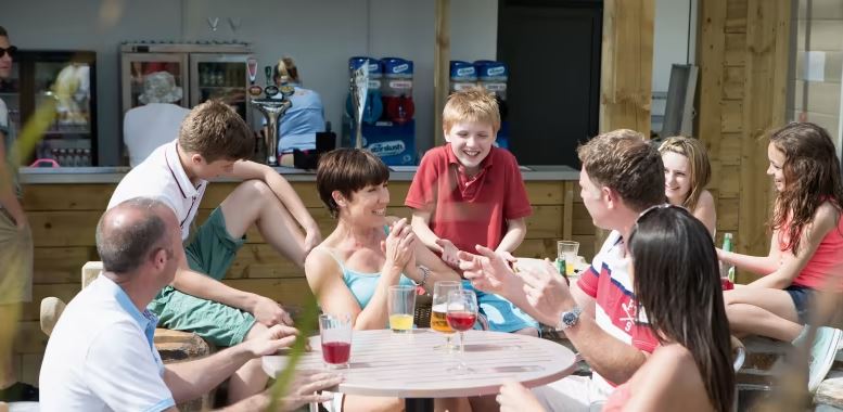 Families Enjoying a Lunch Time Drink on the Holiday Park Pub in Cornwall