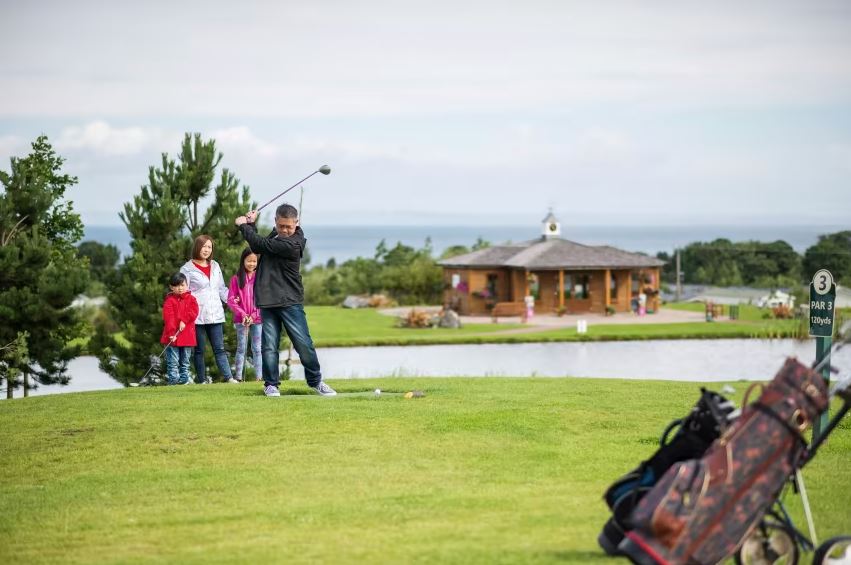 A Family Enjoying a Game of Golf on a top 8 Scotland holiday park