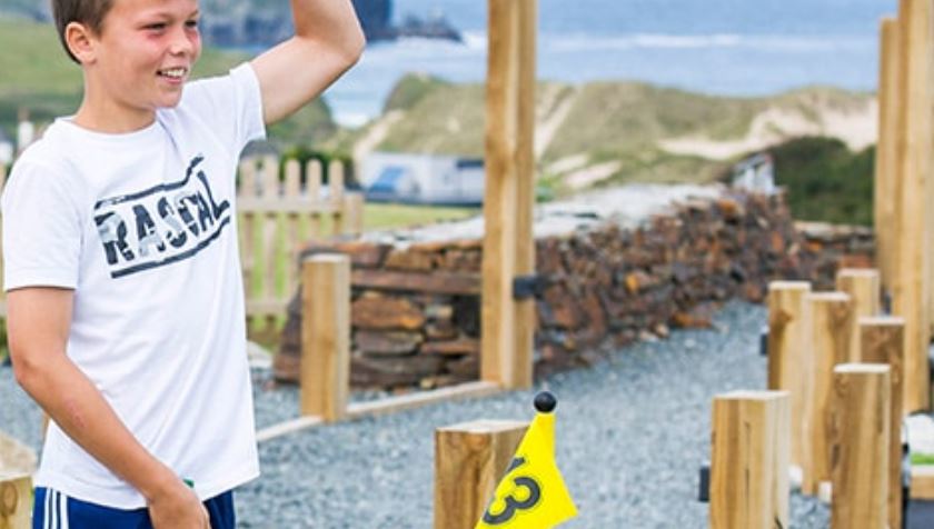 A Child Playing Crazy Golf Overlooking the Sea