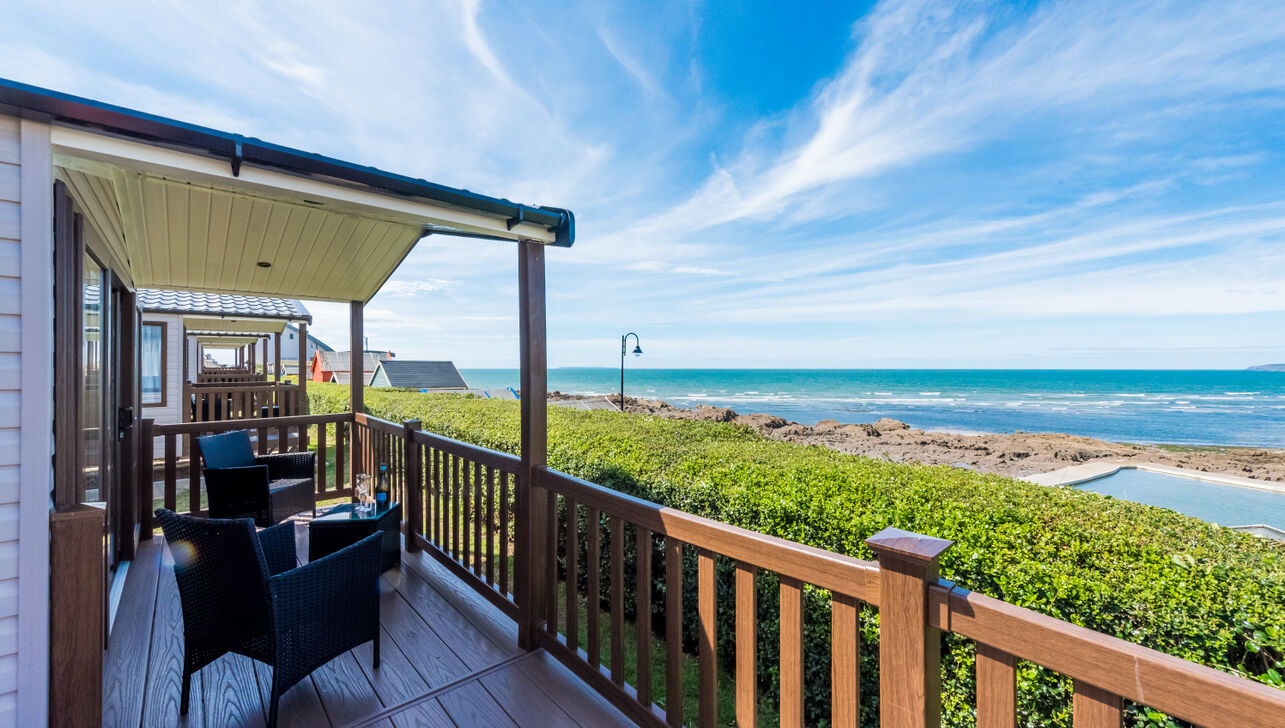 A Caravan Holiday Home Decking Area Overlooking the Sea Pool and Sea at Westward Ho!