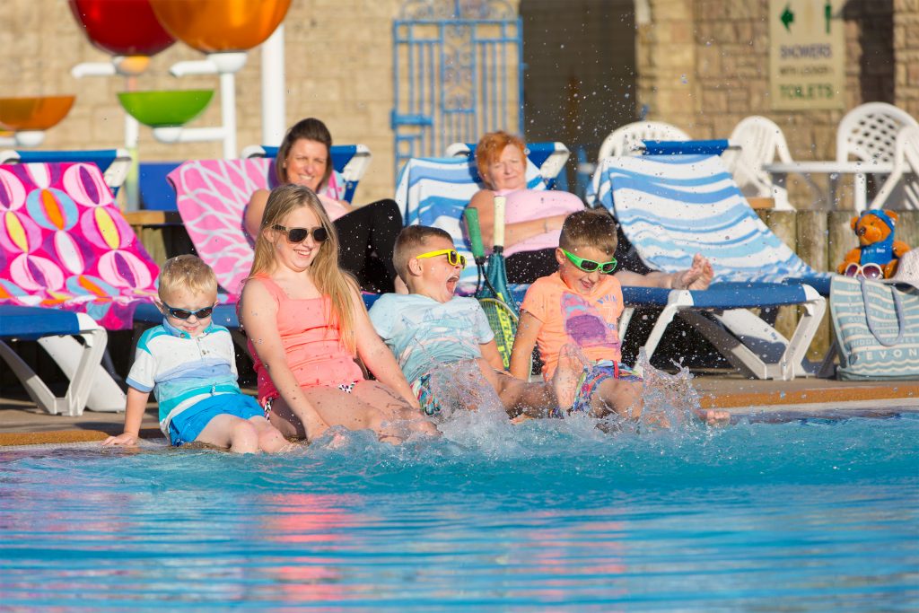 A Family Splashing in the Swimming Pool at holiday parks in Torquay