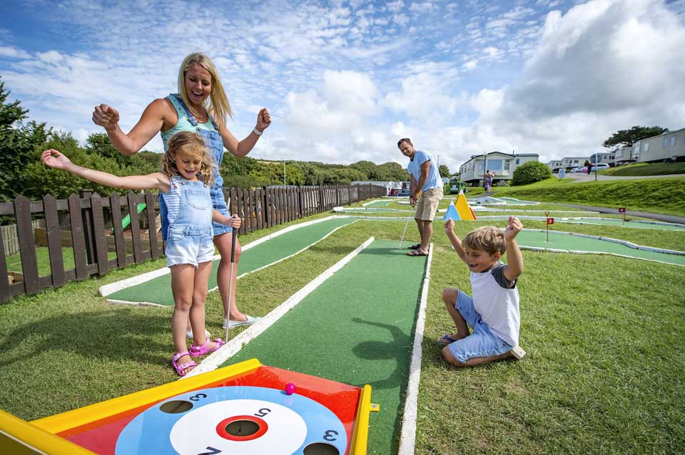 A Family Playing a Game of Crazy Golf on a Cornish Holiday Park