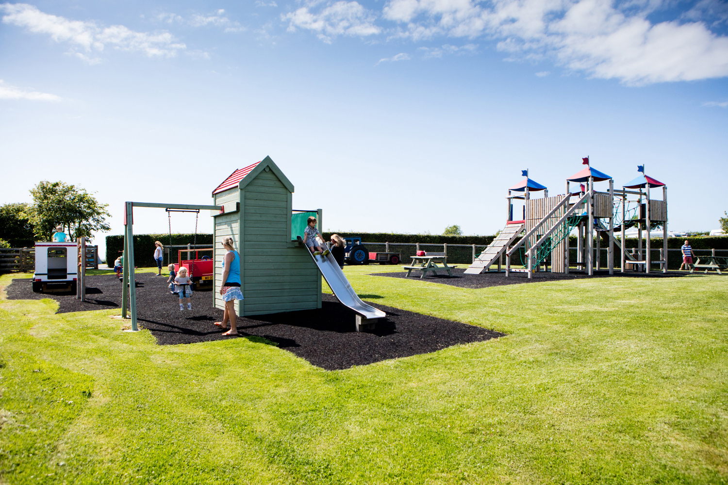Children and Parents on a Playground on a Holiday Park near Bude in Cornwall
