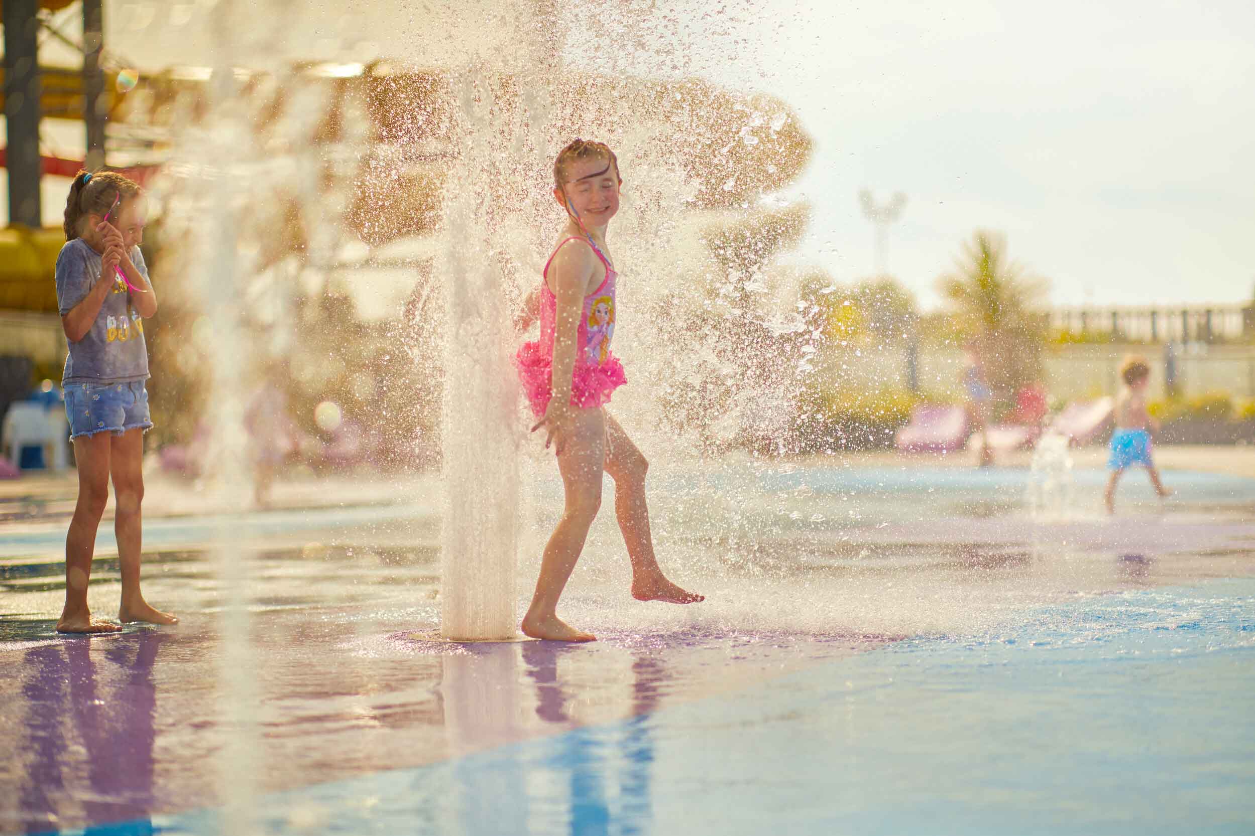 Children Playing in Water Spray Area on a Holiday Park in Skegness