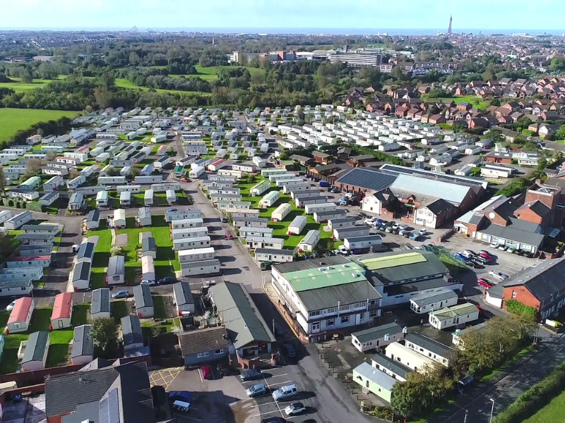 An Arial View of the Holiday Park Surrounded by Trees and the Blackpool Tower in the far Distance