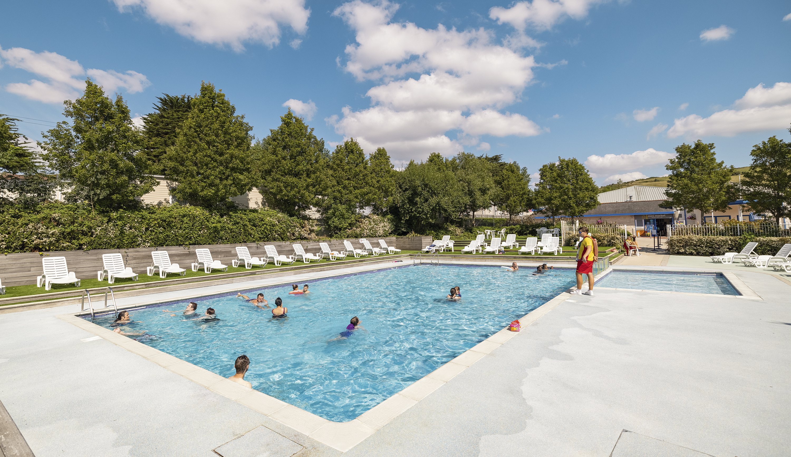 People Swimming in an Outdoor Pool at Seaview holiday park in Weymouth