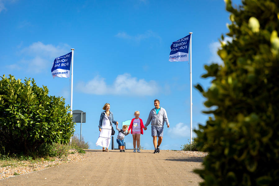 A Family Group Walking at Pevensey Bay Holiday Park Resort from Park Holidays UK