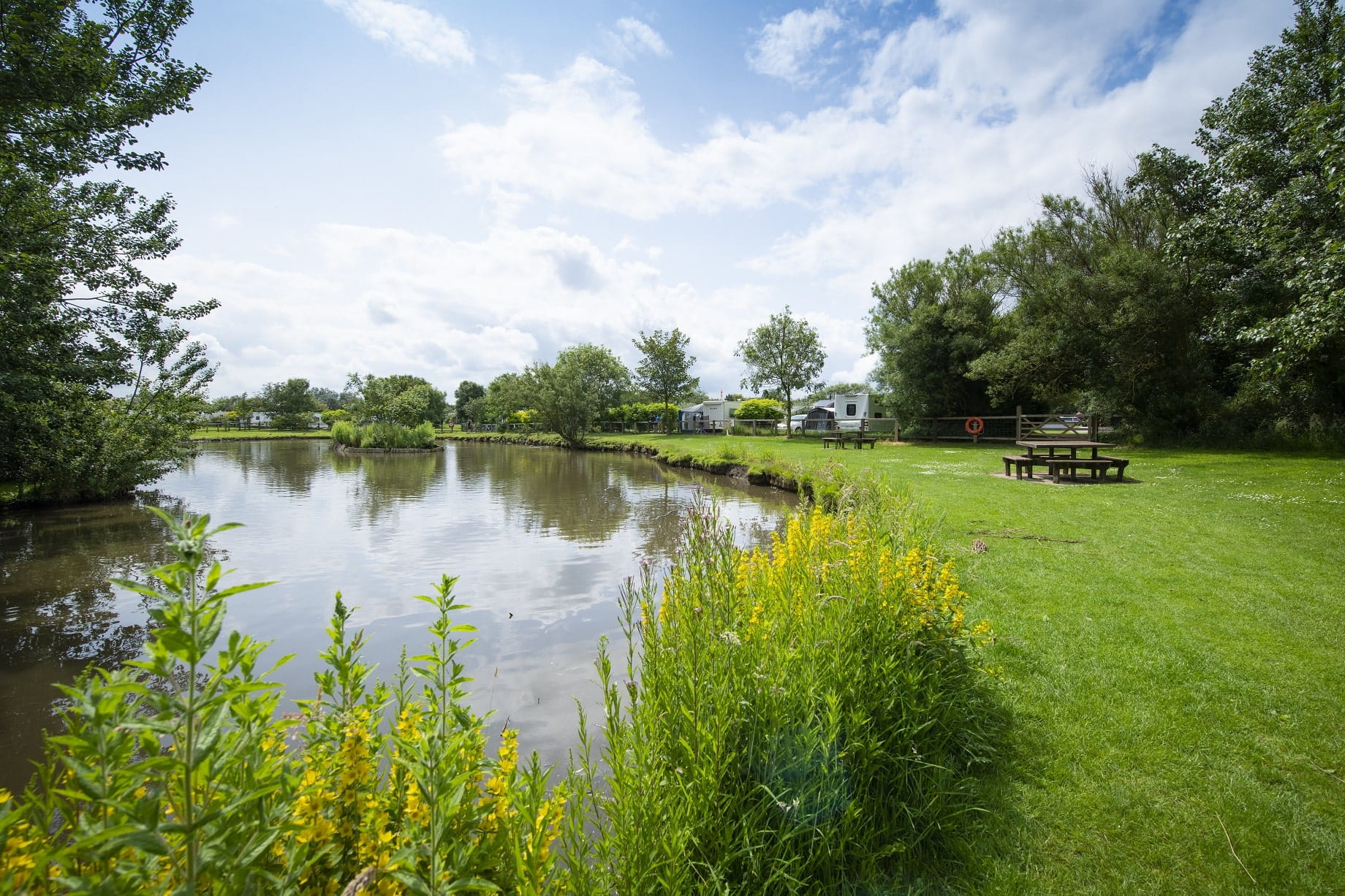 A Fishing Lake Near some Caravans