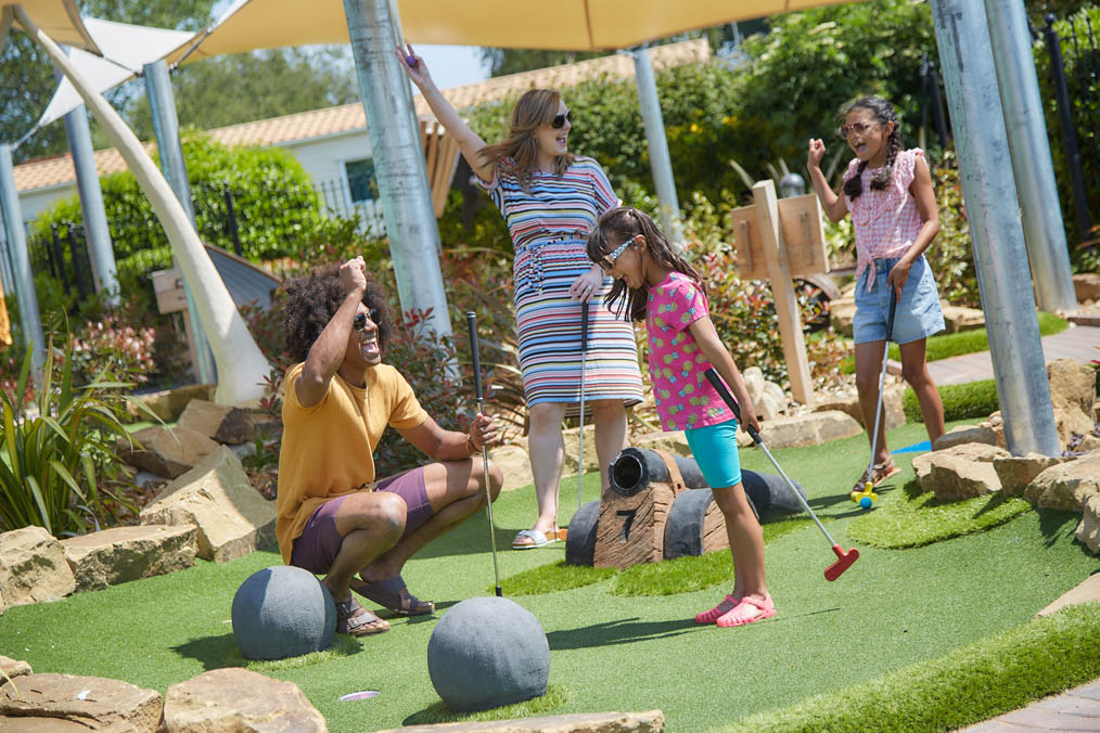 Family enjoying a game of Crazy Golf on a Holiday Park