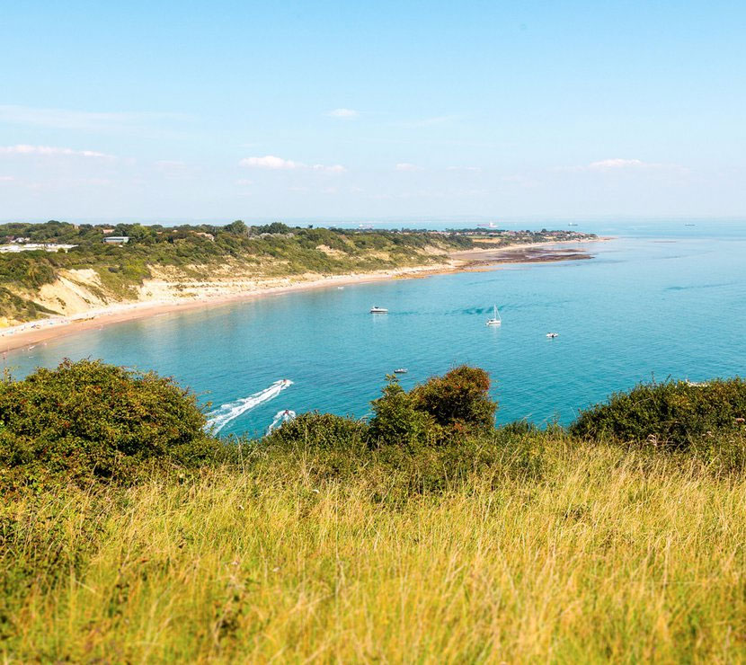 Boats in the Sea near the Away Resorts Whitecliff Bay Holiday Park