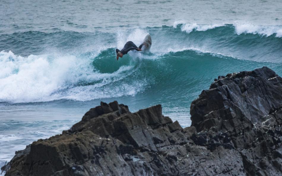 A surfer at high tide, Sandymouth