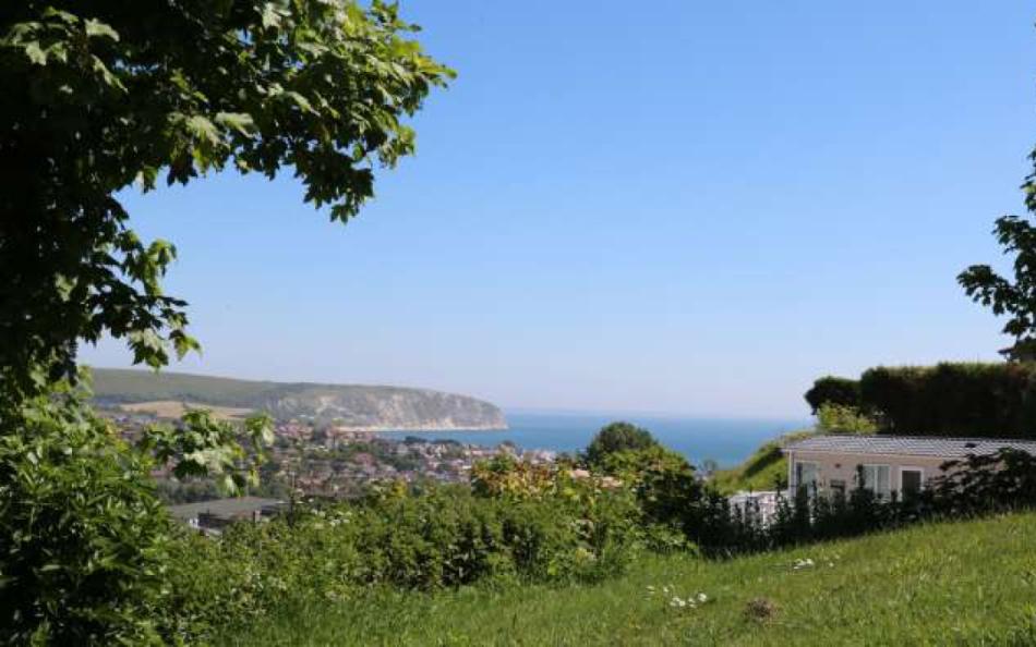Views over Swanage bay of sea with forests for Dorset caravan holidays