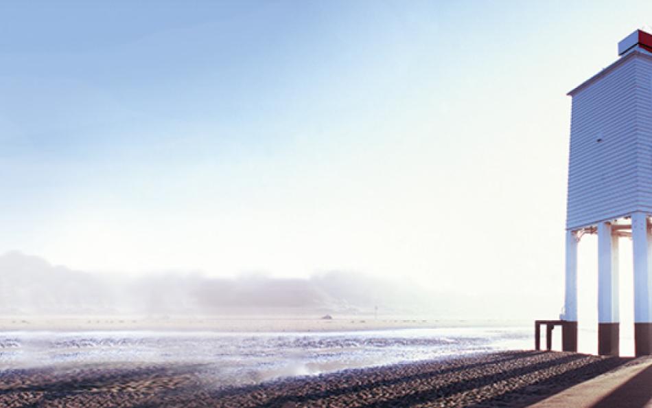 Building on a beach on a sunny day with sea mist