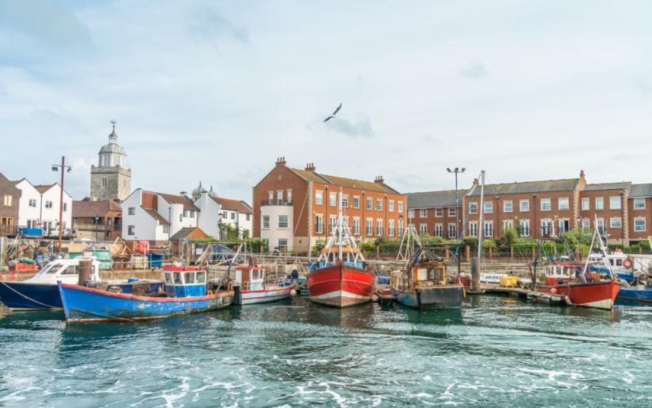 Boats in a harbour with buildings behind