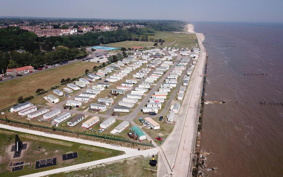 An arial view of the holiday park alongside the coastline and town in the distance