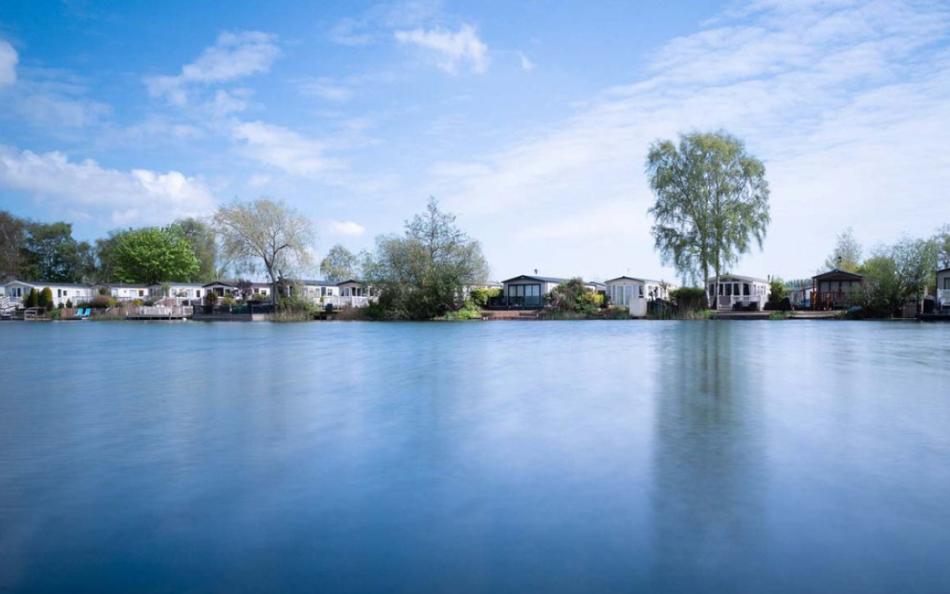 A view of holiday homes and a beautiful lake at Tattershall Lakes Country Park in Lincolnshire