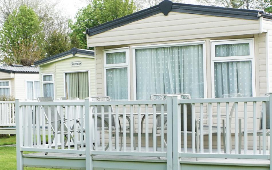 A view of holiday homes and green trees at Woodthorpe Leisure Park in Lincolnshire