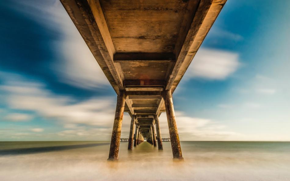 A view from under a pier looking out to sea