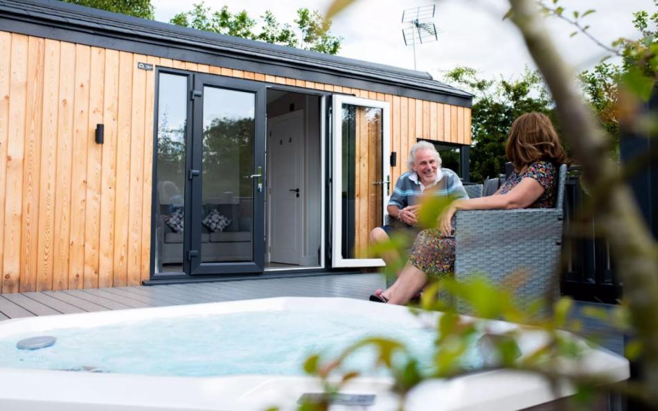 A couple sitting on the deck area of their holiday home