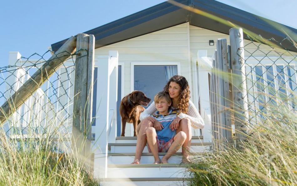 Two people and their dog at Barmouth best holiday parks in Wales