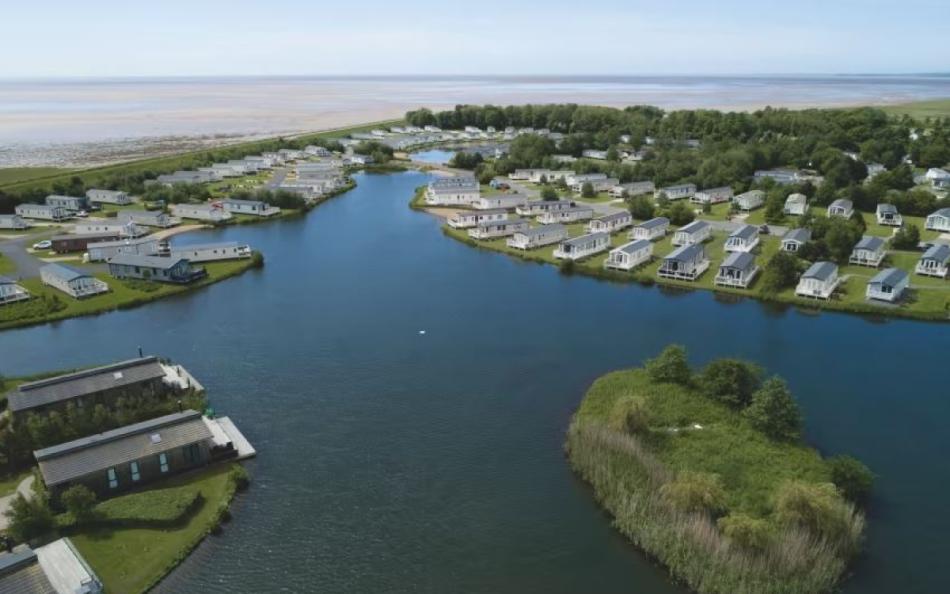 An arial view of the holiday park, lake and coastline