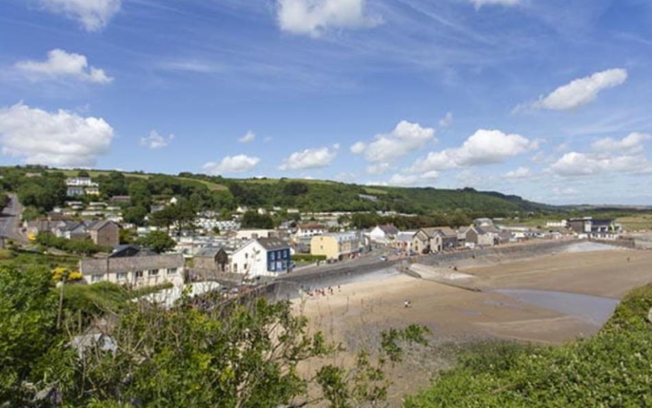 A small village next to a deserted beach on a warm sunny day