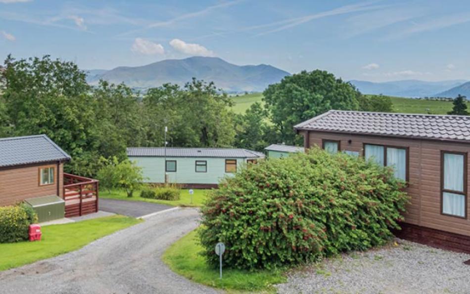 A view through a valley with holiday homes in the forground