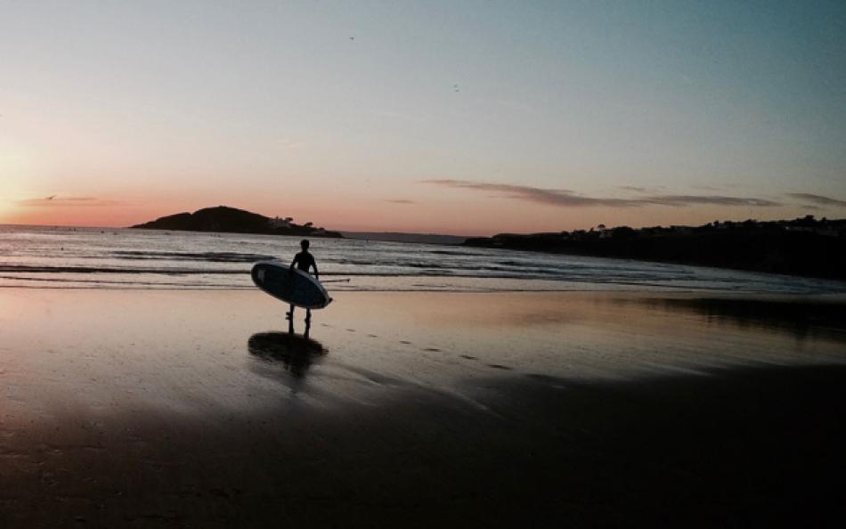 Bantham Beach at Sunset with a Lone Surfer Walking Towards the Surf 