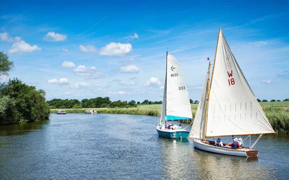 Sailing Boats on a River near a Holiday Park in Norfolk
