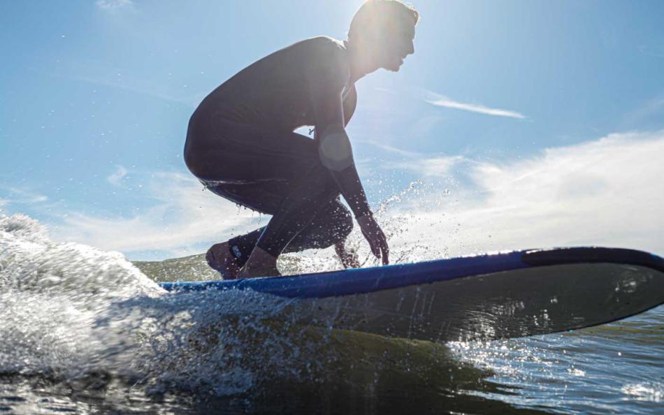 A Person Surfing on a North Devon Beach on a Bright Sunny Day